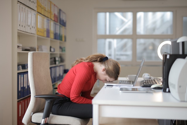 Woman_Falling_Asleep_At_Desk_Struggling_To_Concentrate